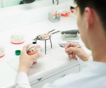 a lab technician creating new dentures