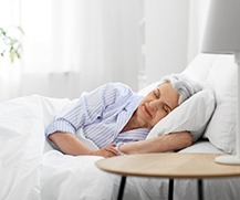 Woman asleep with dental implants