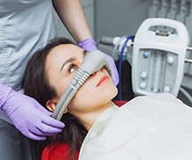 Young woman wearing nitrous oxide mask 