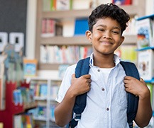 Boy smiling in school library 